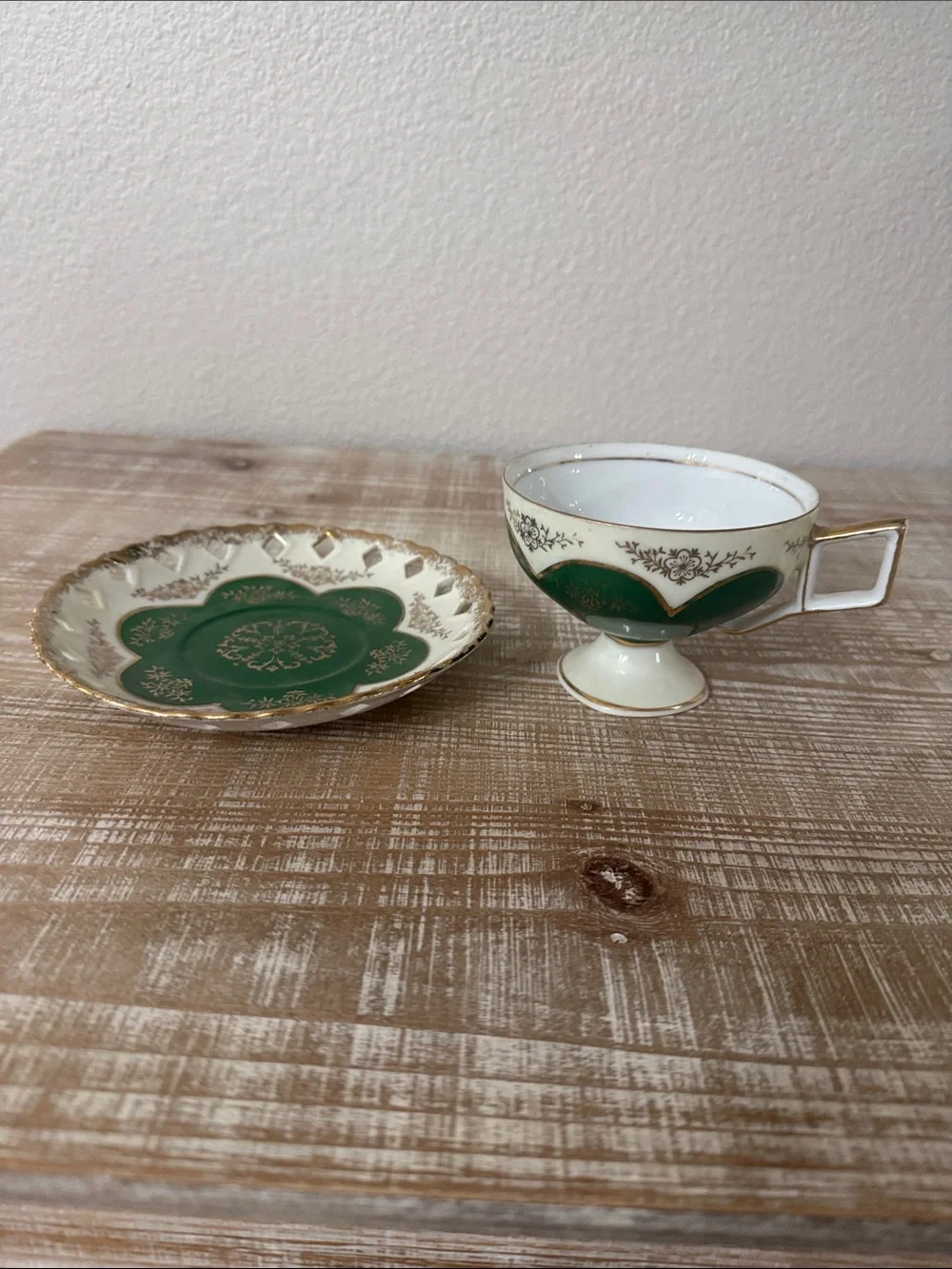 Vintage Japanese green and gold reticulated teacup, and pierced saucer.